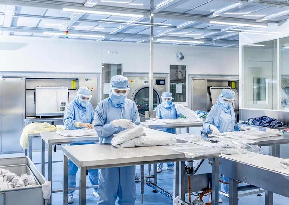 How are cleanroom garments cleaned