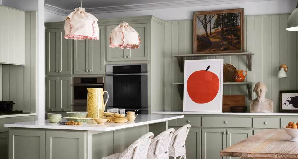 Vintage kitchen cabinets painted with Holiday Red Milk Paint, showcasing a distressed finish and mercury glass knobs