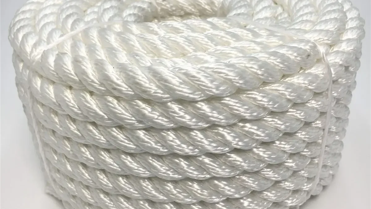 Coiled Faxco 10ft triple-strand cotton rope showcasing its natural texture and triple-twist design for versatile use.