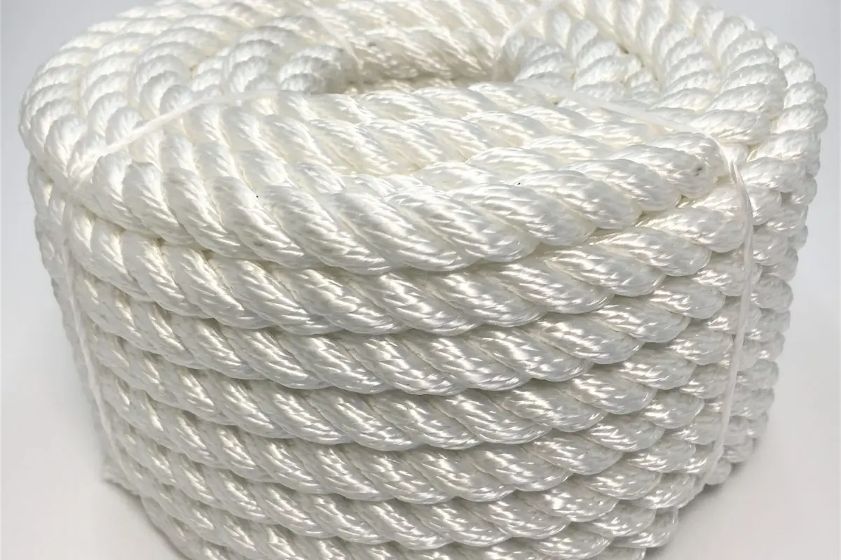Coiled Faxco 10ft triple-strand cotton rope showcasing its natural texture and triple-twist design for versatile use.
