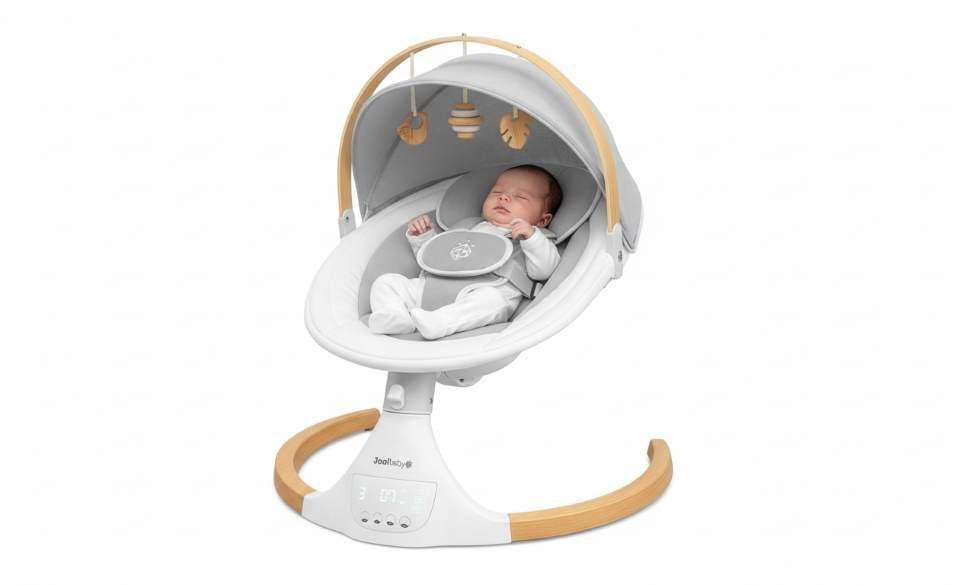 Jool Baby Nova Nature electric baby swing with newborn relaxing under removable canopy and natural beechwood toys