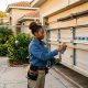 Orlando homeowner inspecting garage door tracks to prevent leveling problems