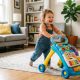 Smiling toddler pushing colorful plastic baby walker across bright living room rug.
