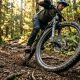 Close up shot of a mountain bike wheel spinning on a dirt trail.