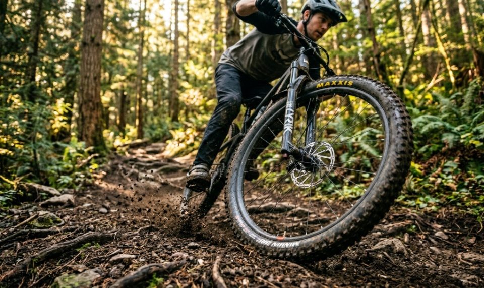Close up shot of a mountain bike wheel spinning on a dirt trail.