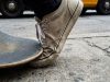 Skateboarder checking toe space inside skate shoes before riding